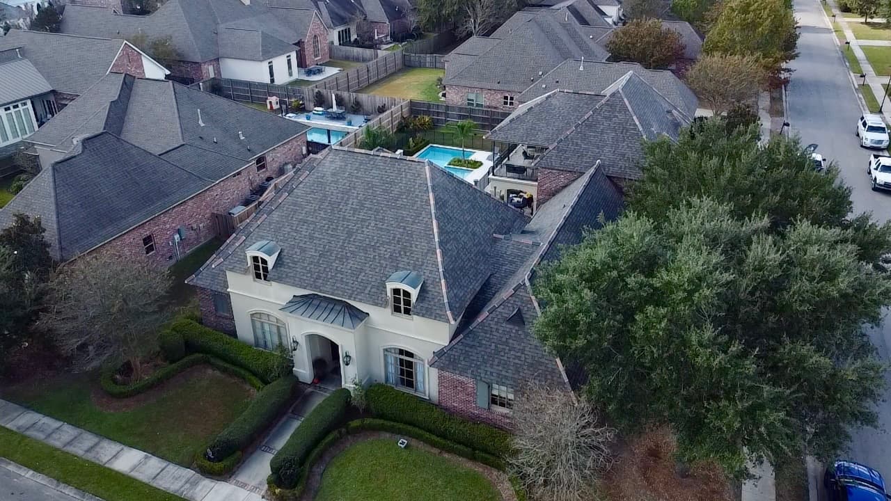 Storm damage to a residential roof in South Louisiana after a hurricane