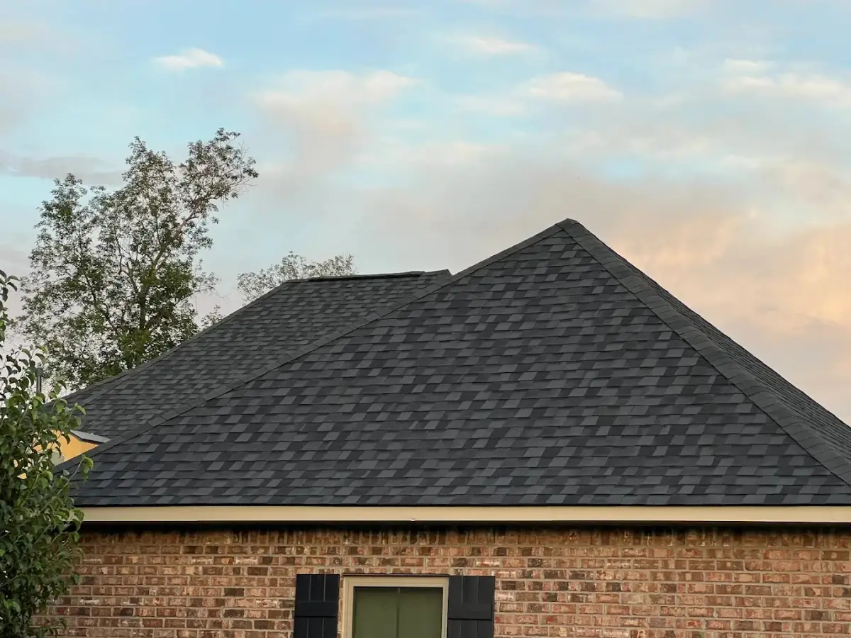 Roofing contractor assessing damage on a residential roof in Prairieville LA